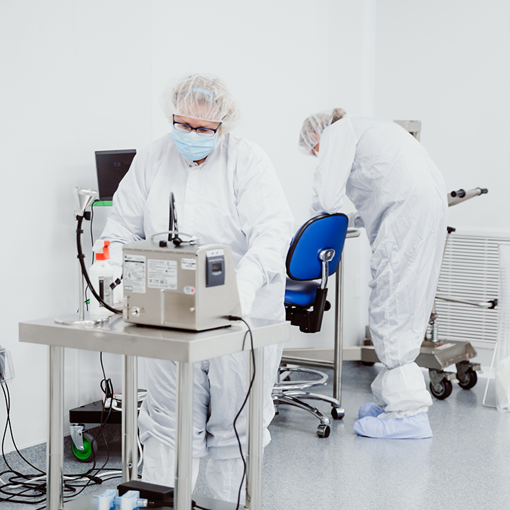 Worker in Sterile Gown Performaing Sampling and Handling for Client Products