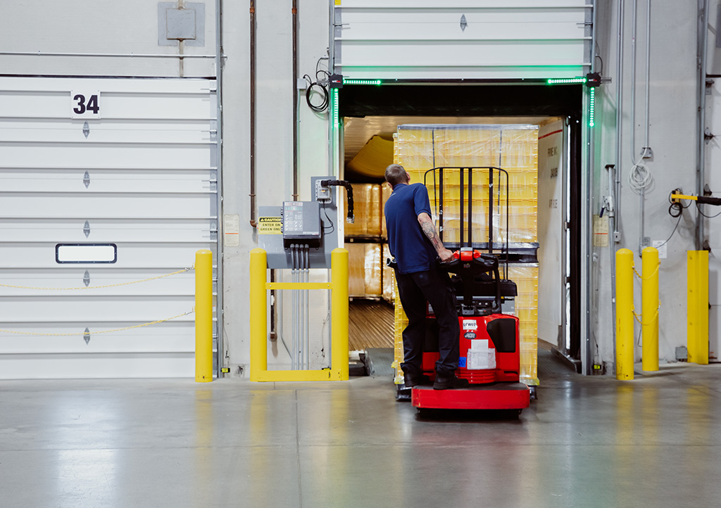Worker Driving Forklift Providing Efficient Supply Chain Solutions for Healthcare Industry